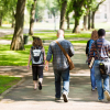 A group of people walking down the sidewalk.
